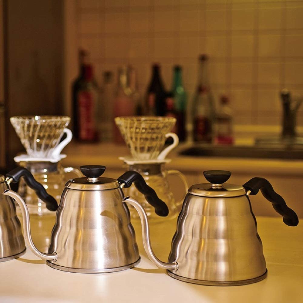 Coffee kettles on kitchen counter top next to coffee pourovers