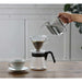 Hario air kettle being poured into v60 pourover on kitchen table