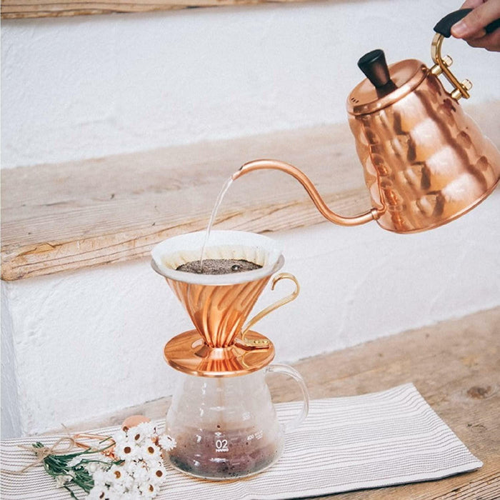 Hario v60 copper dripper with size 02 glass server, being poured in with copper hario kettle